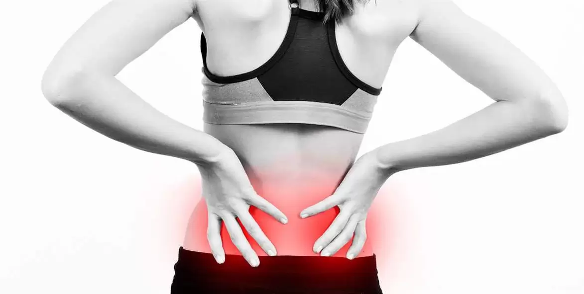 Pain in the lower back, which can be relieved by exercise and correct body position